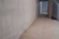 Close-up view of basement concrete foundation walls insulated with smooth closed-cell spray foam by Classic Spray Foam.